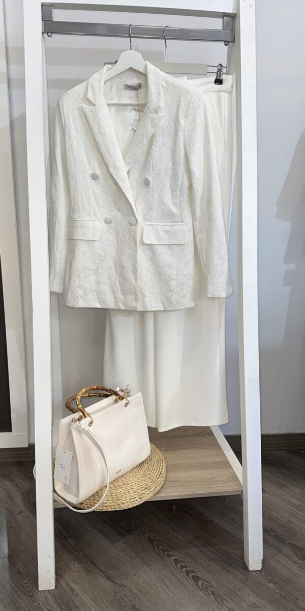 Traje blanco elegante de chaqueta y falda de encaje, combinado con bolso de cuero de asa de bambú. Disponible en Arezzo, tienda online de moda y complementos femeninos, para un look sofisticado y moderno.